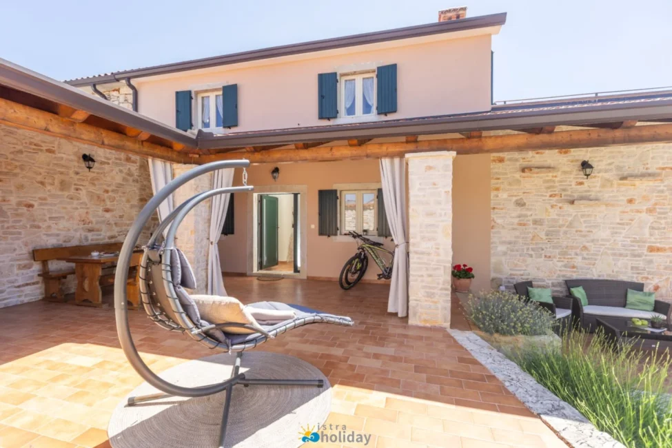 Stone patio with hanging chair and outdoor seating