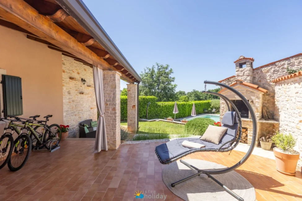 Covered patio with lounge chair and pool