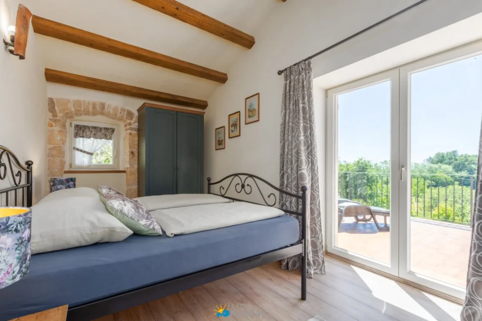 Cozy bedroom with balcony and countryside view