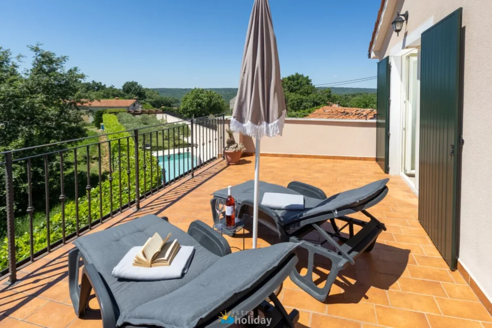 Sunny terrace with lounge chairs and countryside view
