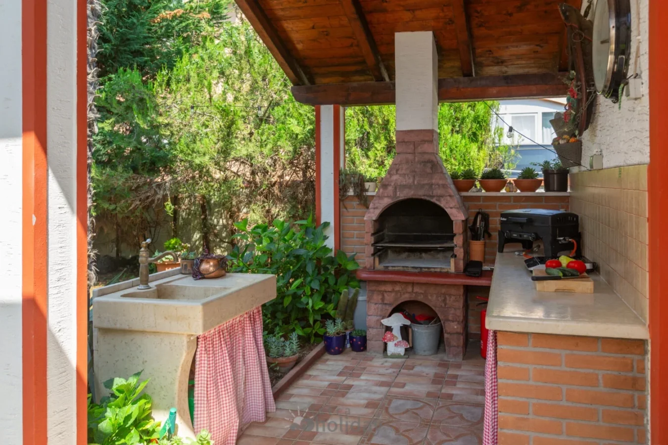 Outdoor kitchen with brick oven and countertop.