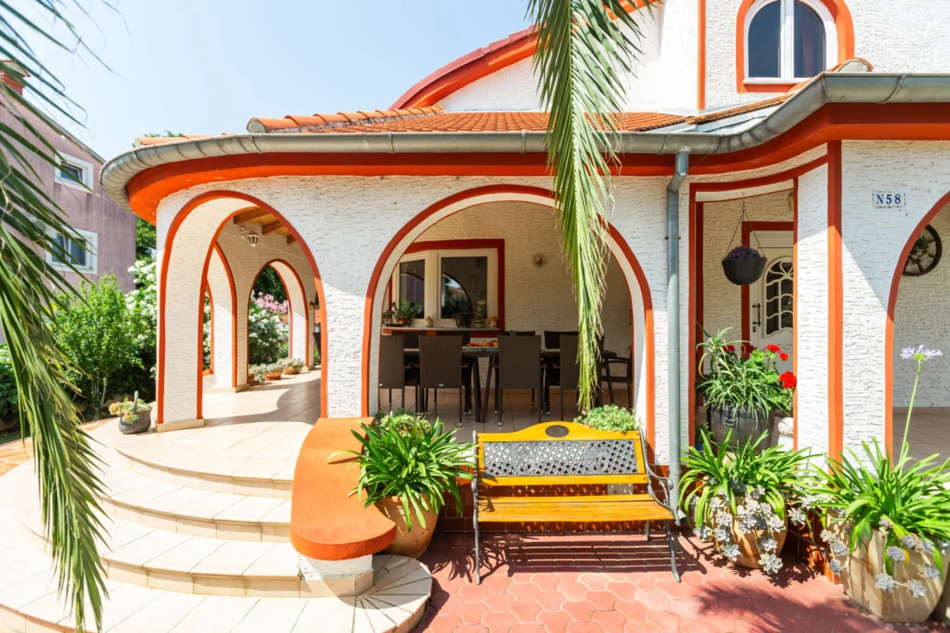 Charming porch with arches and outdoor seating area.