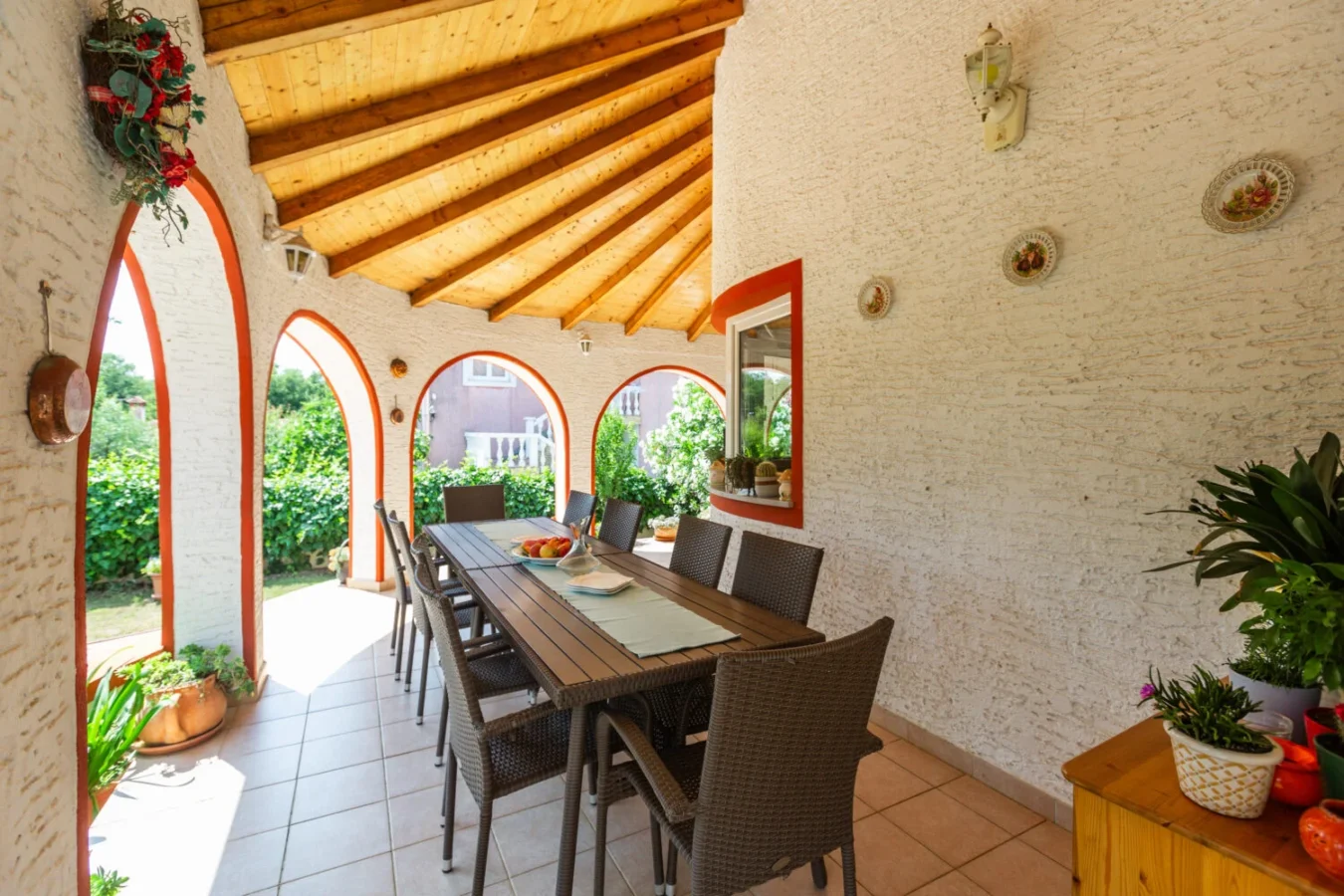 Outdoor dining area with wooden ceiling and table