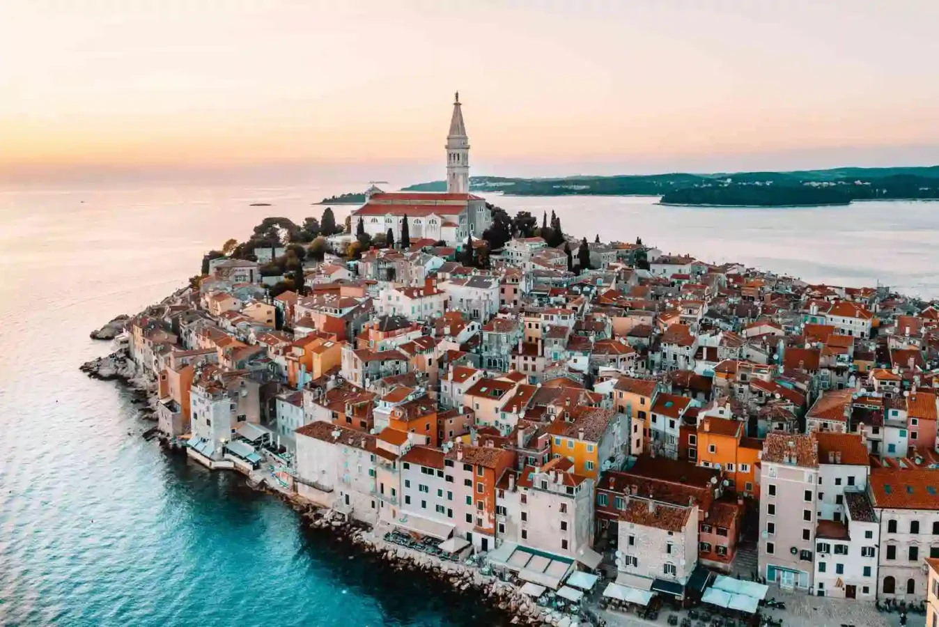 Coastal town with church tower at sunset