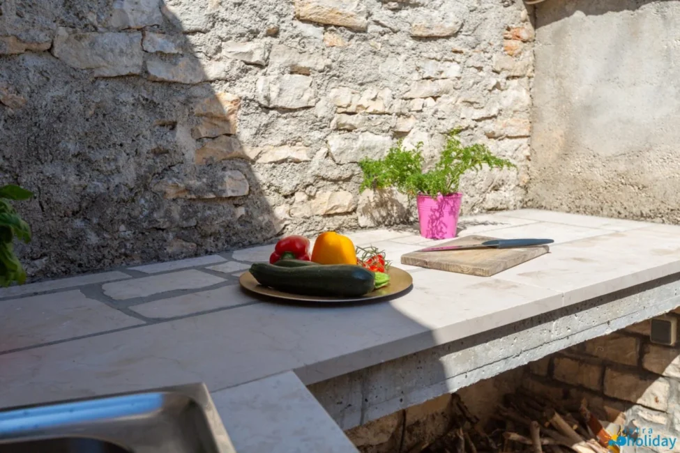 Outdoor kitchen with fresh vegetables and herbs