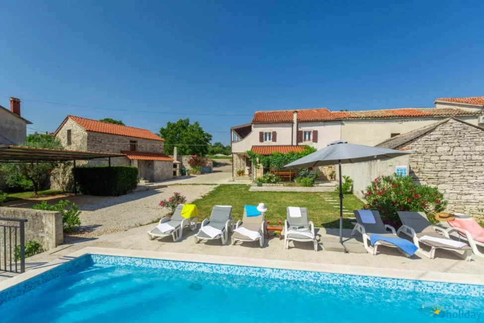 Rustic villa with pool and lounge chairs