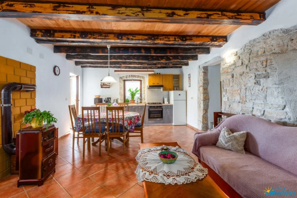 Rustic kitchen and dining area with wooden beams