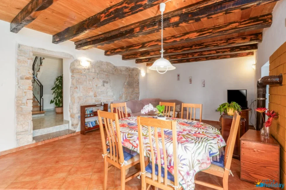 Rustic dining room with floral tablecloth.