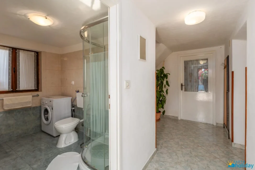 Bathroom with laundry and shower area.