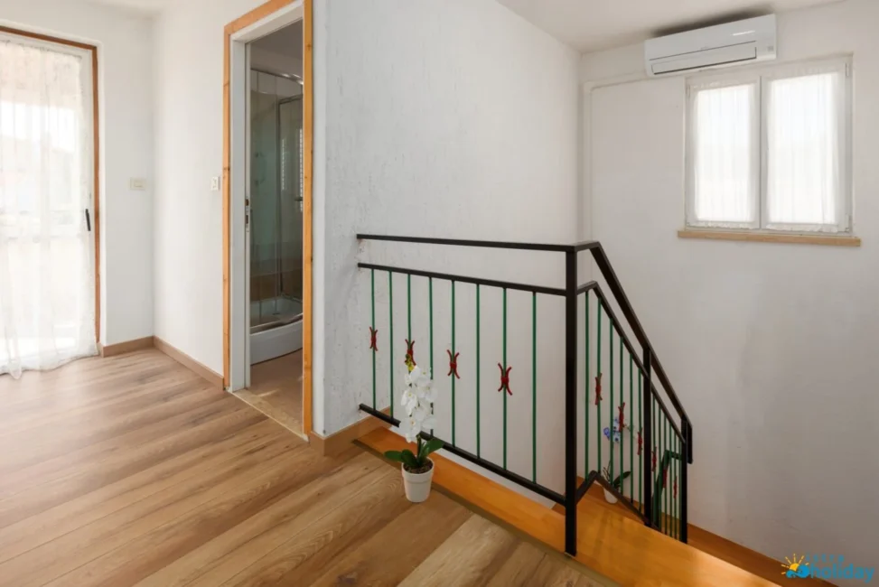Modern hallway with stairs and wooden floor