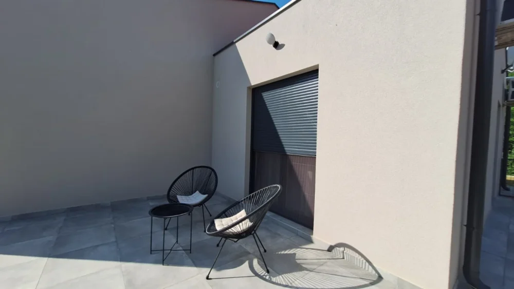 Modern patio with two chairs and small table